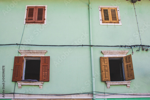 bright green house with open shutters in Pula, Istrian Peninsula in Croatia