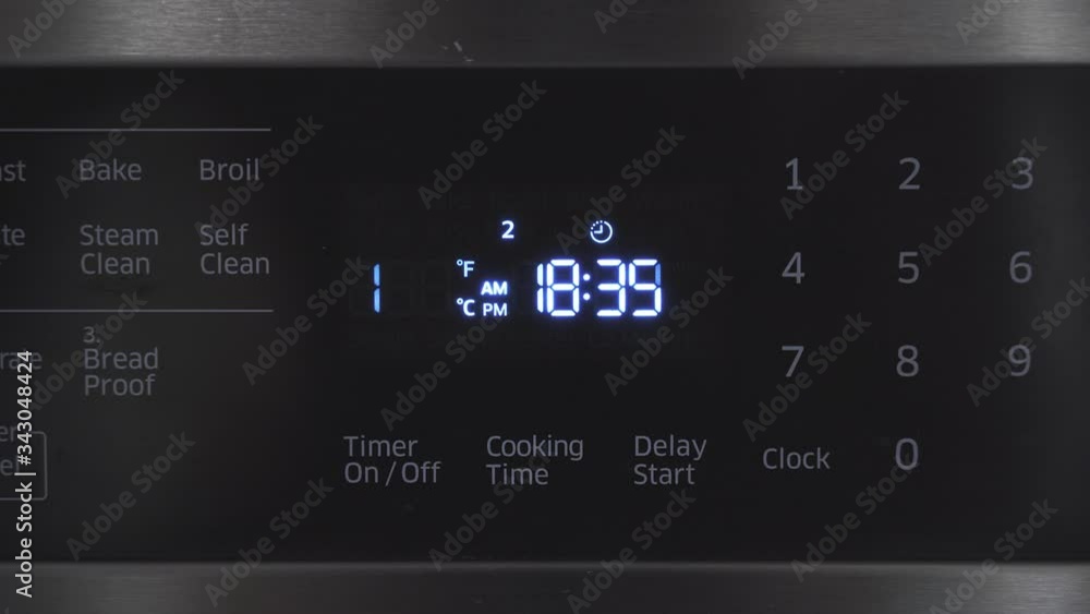 Close up of oven display flickering, control panel blinking. Electricity problem Close up of oven display flickering, control panel blinking. Electricity problem
