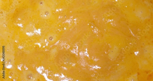 Fondue of fragrant cheese is boiling in the pot.