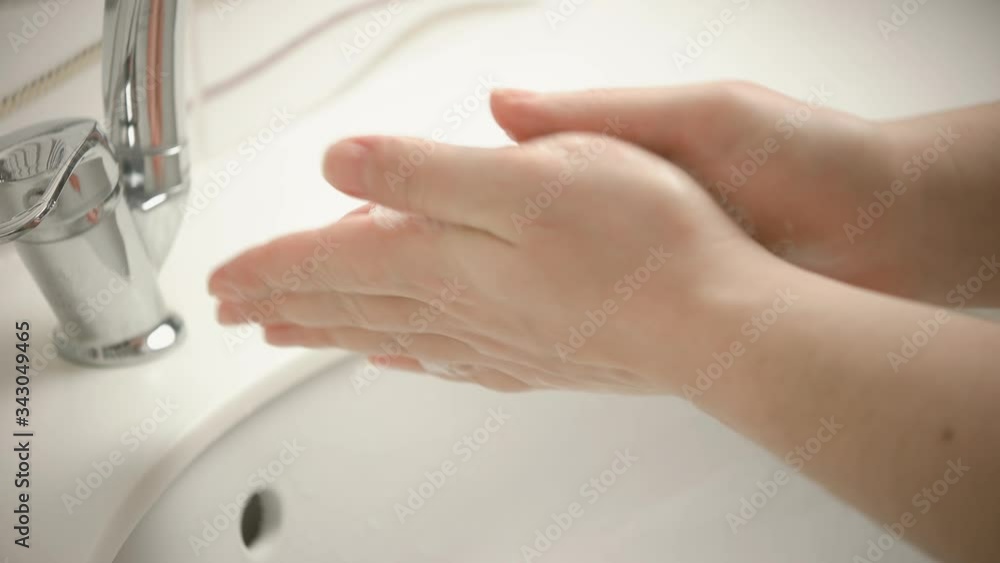 Hand wash. The woman is washing her hands by surgical methods. Protection from Coronavirus. Wash your hands for at least 20 seconds. Hand wash. The woman is washing her hands by surgical methods. Protection from Coronavirus. Wash your hands for at least 20 seconds.