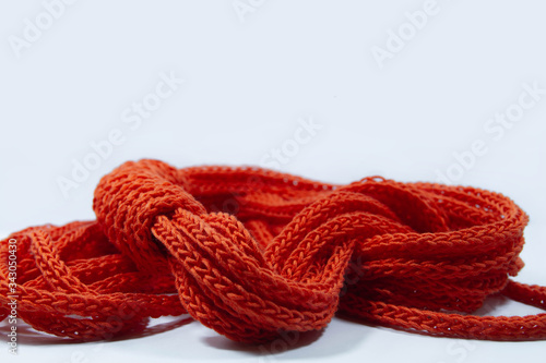 Orange spool knitted cord scarf isolated