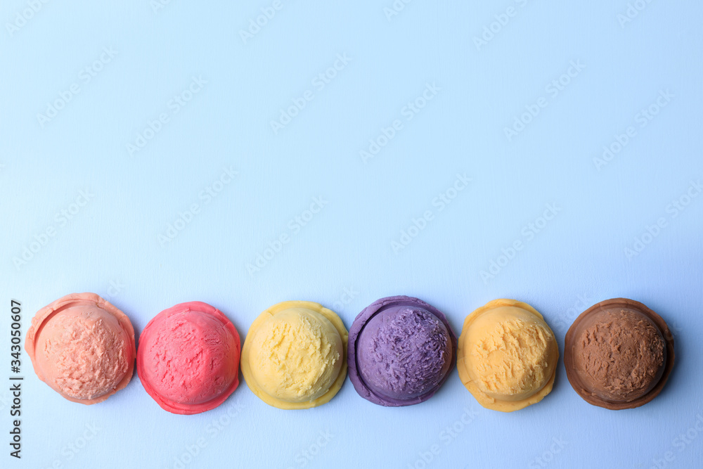 Set of ice cream scoops of different colors and flavors on blue table, copy space. Food background, summer refreshing concept, traditional seasonal cold sweets Set of ice cream scoops of different colors and flavors on blue table, copy space. Food background, summer refreshing concept, traditional seasonal cold sweets