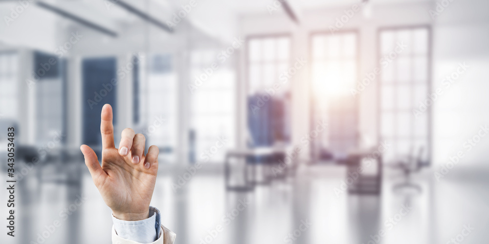 Choosing gesture of businessperson in elegant modern interior in sunshine light Choosing gesture of businessperson in elegant modern interior in sunshine light