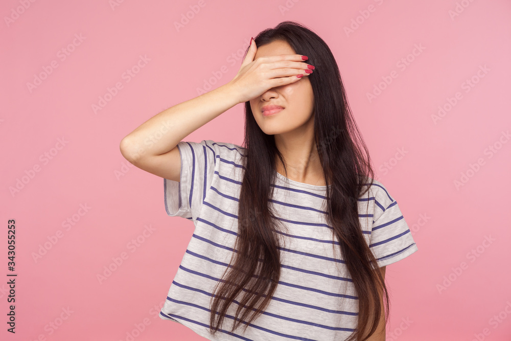 Don't want to watch! Portrait of confused girl with long hair in striped t-shirt hiding eyes, refusing to look at shameful bad events, ignoring problems. indoor studio shot isolated on pink background Don't want to watch! Portrait of confused girl with long hair in striped t-shirt hiding eyes, refusing to look at shameful bad events, ignoring problems. indoor studio shot isolated on pink background