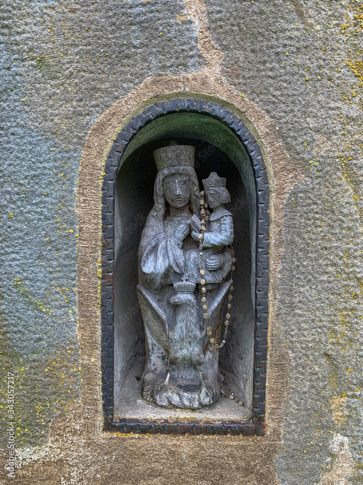 Ancient sculpture of the Madonna holding the child in her arms.