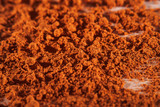 Background with sprinkled paprika at high magnification and an empty white background