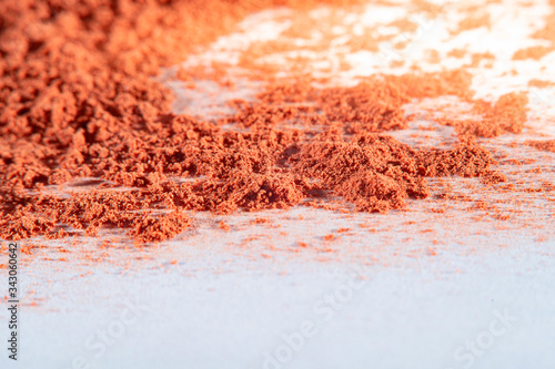 Background with sprinkled paprika at high magnification and an empty white background with a place for inscriptions