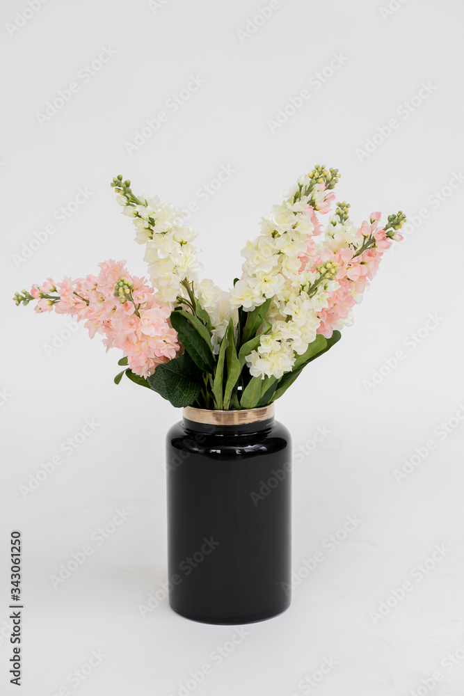 white color bouquet in a black glass vase