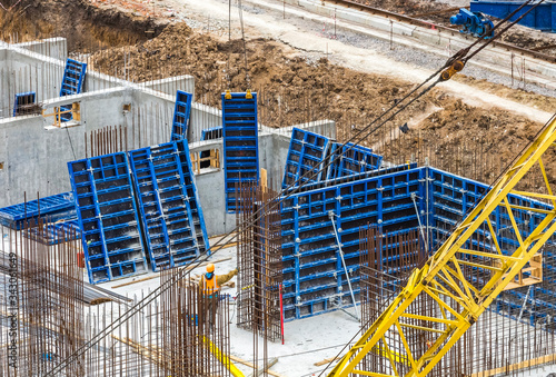 Construction workers install formwork and iron rebars or reinforcing bar for reinforced concrete partitions at the construction site of a large residential building. photo
