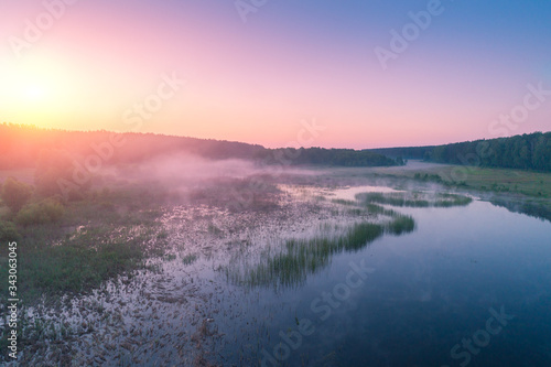 Early misty morning. Sunrise over countryside. Rural landscape in early spring. Aerial view