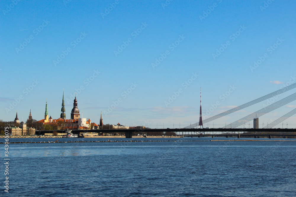Panoramic view of opposite bank of the river Daugava. View at the Old Town of Riga and church towers.