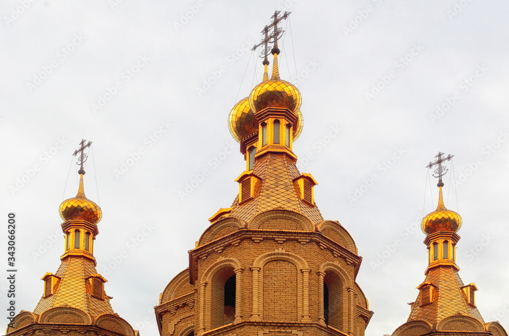 Christian church, golden domes, sunny day, toned
