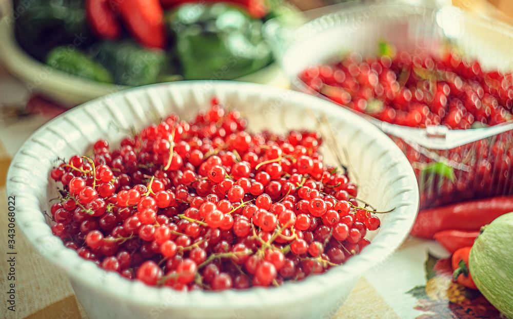 Red currant berries in a bowl on the table, harvest Red currant berries in a bowl on the table, harvest