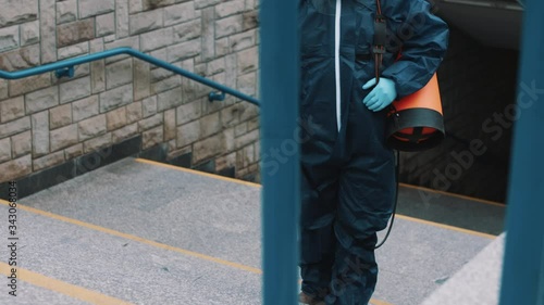 African man with protective suit disinfecting the streets. Prevention of the coronavirus spread