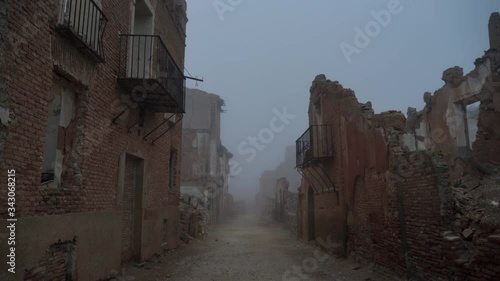 Ghost town covered with fog. Bombed war town in coldwinter photo