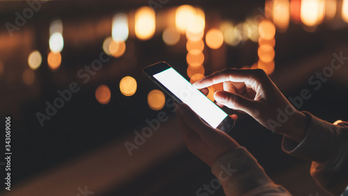 person text message on background blur color light night city, hipster touch on mock up screen mobile phone, girls holding in hands smartphone, mockup blank screen