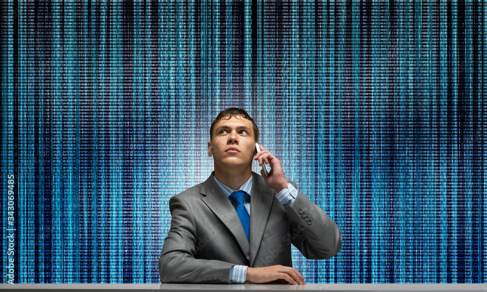 Young man talking on phone and looking upward. Young man talking on phone and looking upward.