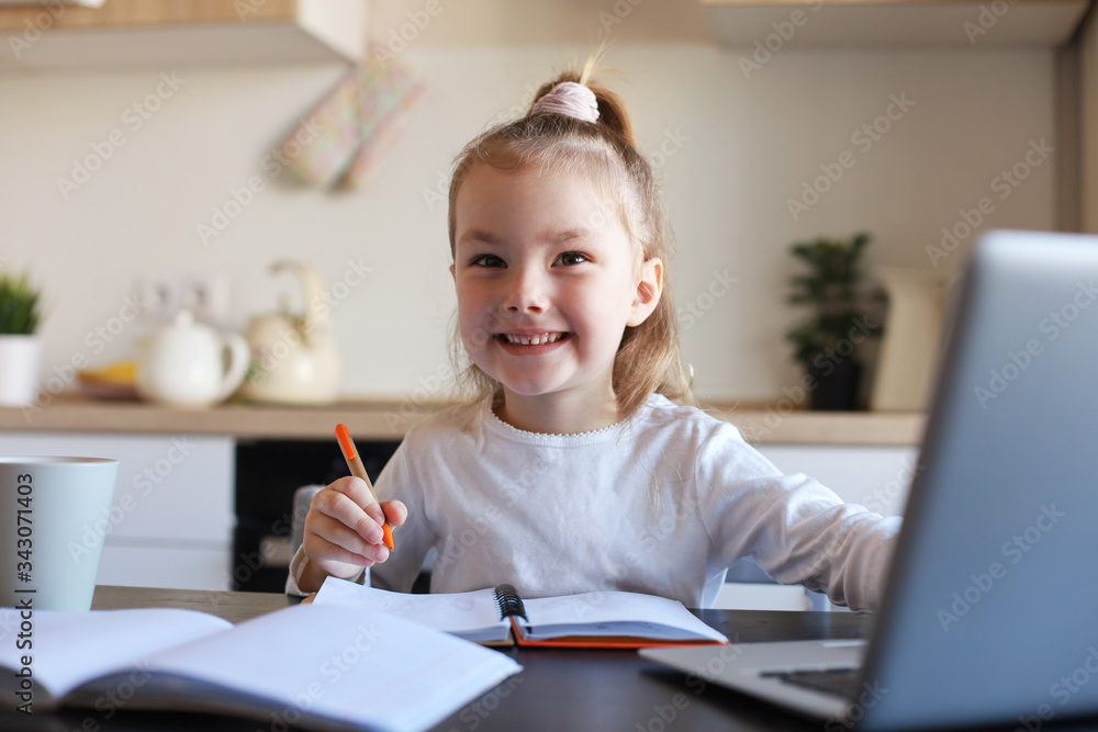 Smiling little girl handwrite study online using laptop at home, cute happy small child take Internet web lesson or class on PC. Smiling little girl handwrite study online using laptop at home, cute happy small child take Internet web lesson or class on PC.