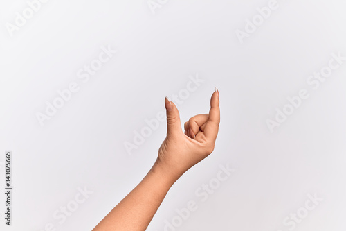 Hand of caucasian young woman picking and taking invisible thing, holding object with fingers showing space