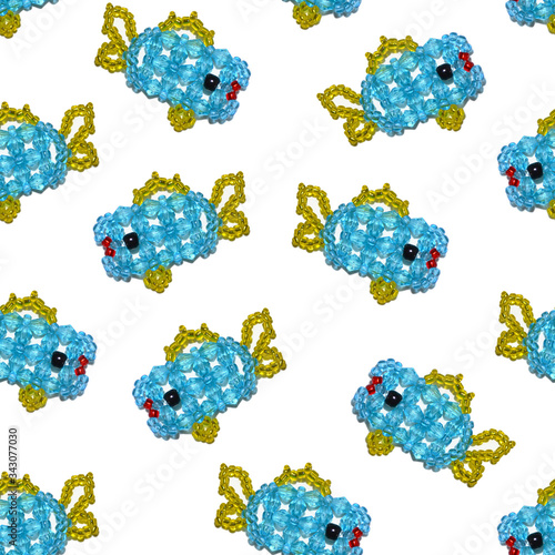 Seamless pattern of a blue beaded fishes on a white background, beading, beadwork
