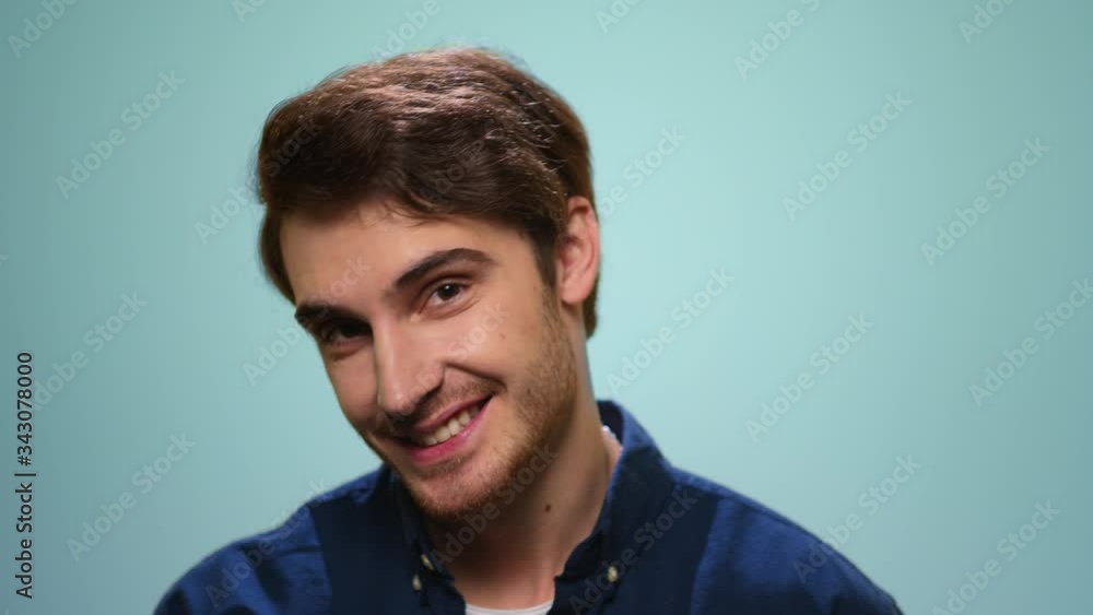 Man flirting with camera on blue background. Portrait of bearded man biting lips Man flirting with camera on blue background. Portrait of bearded man biting lips