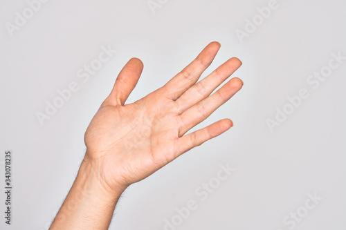 Hand of caucasian young man showing fingers over isolated white background presenting with open palm, reaching for support and help, assistance gesture