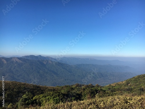 The scenic view from Nishani Betta Peak  Coorg  India. Blue sky  great mountains and valleys.