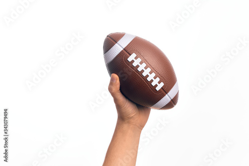 Hand of caucasian young sporty man holding football ball over isolated white background © Krakenimages.com
