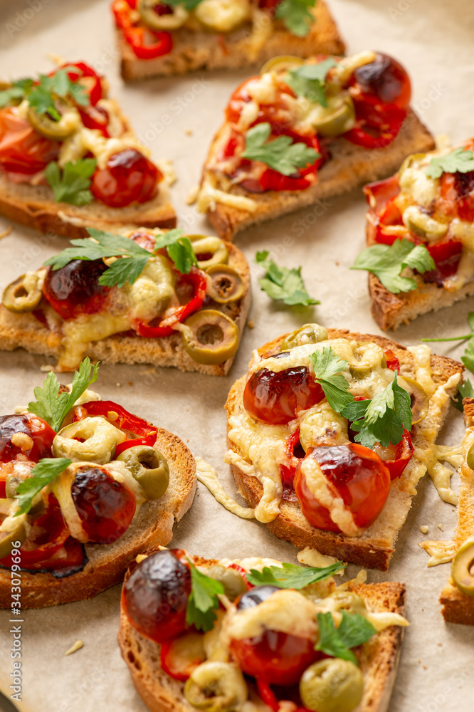 Hot crust toasts with ham, olives, tomatoes and cheese, breakfast idea. Hot crust toasts with ham, olives, tomatoes and cheese, breakfast idea.