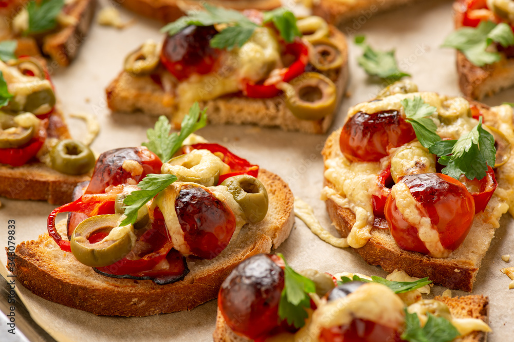 Hot crust toasts with ham, olives, tomatoes and cheese, breakfast idea. Hot crust toasts with ham, olives, tomatoes and cheese, breakfast idea.