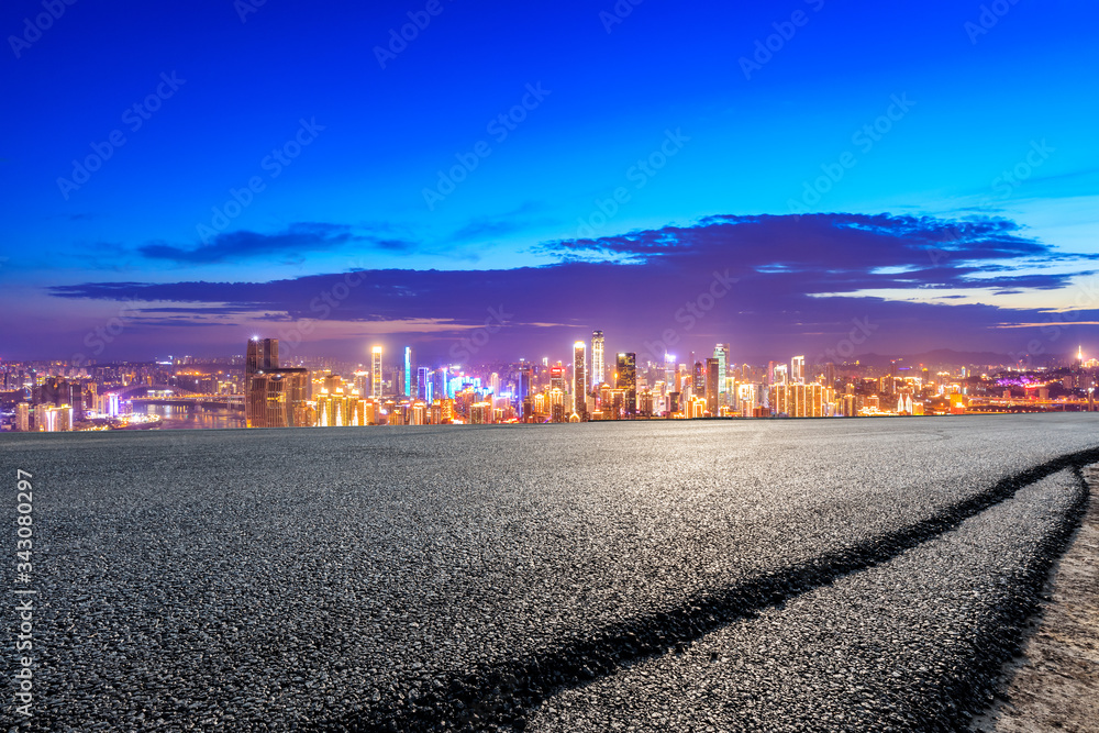 Empty asphalt road and Chongqing city skyline and buildings at night,China.