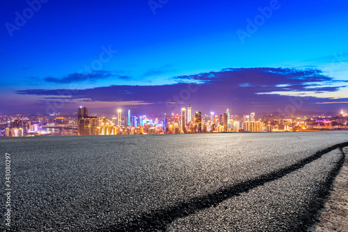Empty asphalt road and Chongqing city skyline and buildings at night China.