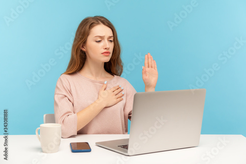 Obraz na płótnie I swear! Honest responsible woman making loyalty promise oath and looking at laptop screen, talking on video call, online conference from home office