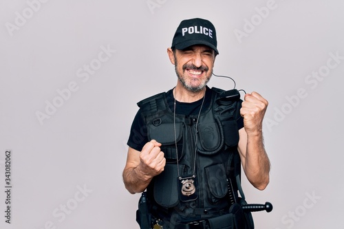Fototapeta Middle age policeman wearing police uniform and bulletproof vest over white back
