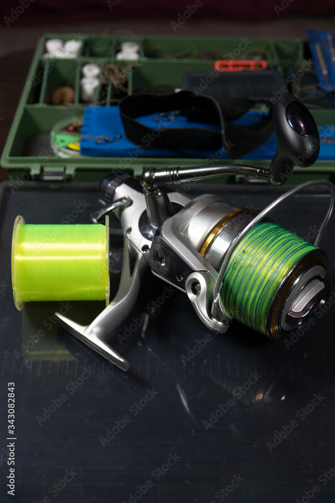 Fishing equipment on a old wooden table. Sport and recreation concept Fishing equipment on a old wooden table. Sport and recreation concept