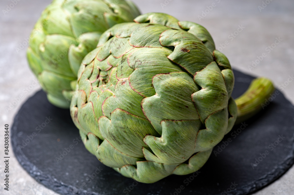 Fototapeta premium Big ripe uncooked green globe artichoks vegetables