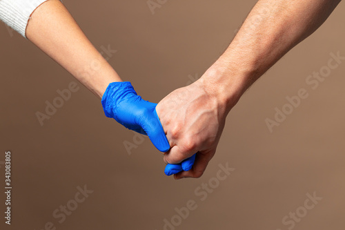 Handshake in a blue gloves, help concept. © fotofabrika