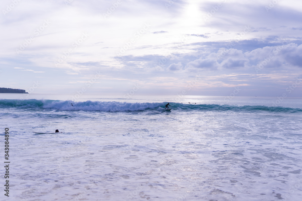 Surfing on the island of Bali in the Pacific and Indian Ocean. Male surfers engage in active sports on sick waves Surfing on the island of Bali in the Pacific and Indian Ocean. Male surfers engage in active sports on sick waves
