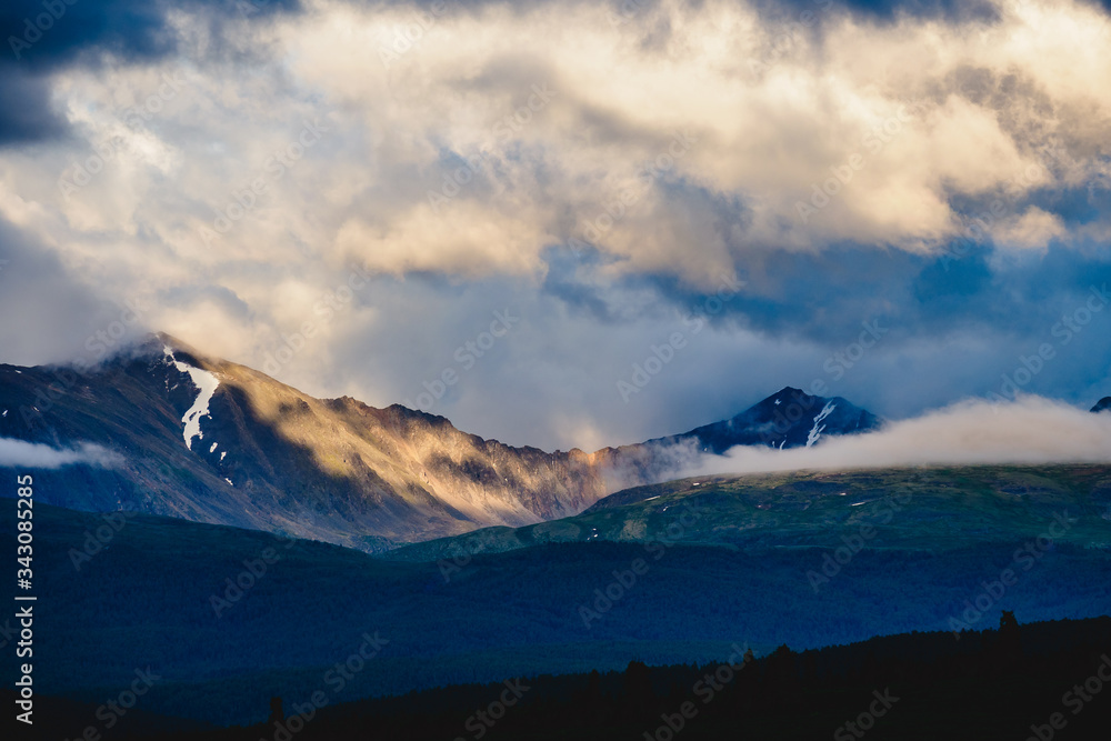 Spectacular view of a mountain range in the clouds in Ulagansky district of the Altai Republic, Russia