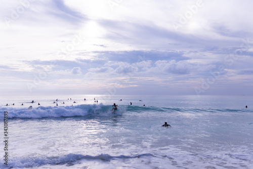 Surfing on the island of Bali in the Pacific and Indian Ocean. Male surfers engage in active sports on sick waves