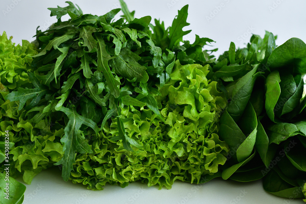 juicy fresh spinach, arugula ,Lettuce salad on a white background.Fresh Organic Raw Greens. vegan, vegetarian concept.Spring avitaminosis.ingredients for detox smoothie juicy fresh spinach, arugula ,Lettuce salad on a white background.Fresh Organic Raw Greens. vegan, vegetarian concept.Spring avitaminosis.ingredients for detox smoothie