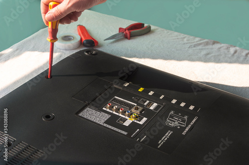 Photography A technician is repairing an LCD TV at work