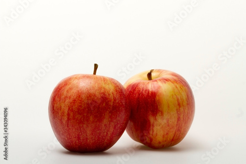 Two apples in red and yellow on a light background