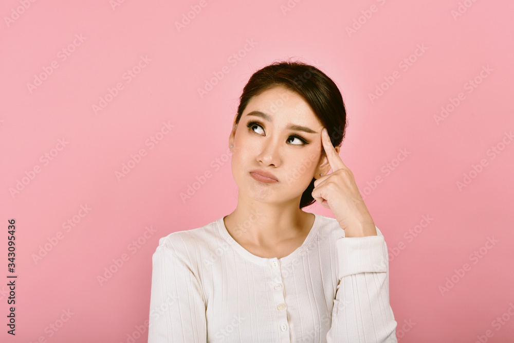 Thoughtful confused and dizzy asian woman, Girl's face expression feeling worry messy problems on isolated pink background. Thoughtful confused and dizzy asian woman, Girl's face expression feeling worry messy problems on isolated pink background.