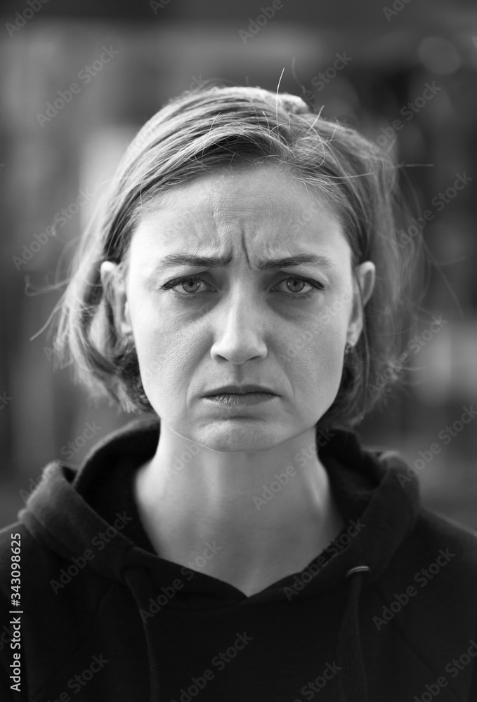 Angry blonde woman looking to the camera. Black and White photo. Angry blonde woman looking to the camera. Black and White photo.