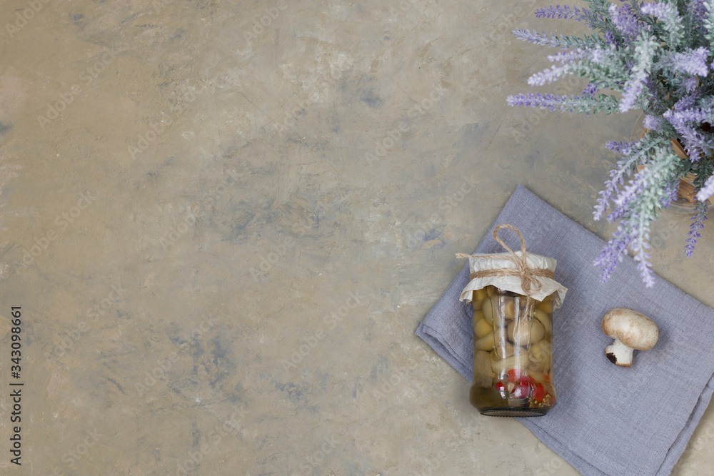 Fototapeta premium Fermented mushrooms and gherkins, cucumbers in a glass jar on a light background.