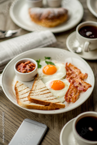 Breakfast with coffee toast with egg juice daylight cafe restaurant towel american wooden table
