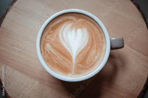 Close up of coffee latte on wood table, top view 