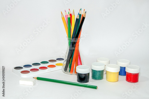 Colored pencils, paints, gouache, watercolors on a white background