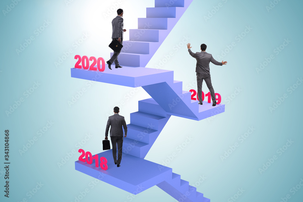 Businessman climbing stairs on yearly basis Businessman climbing stairs on yearly basis